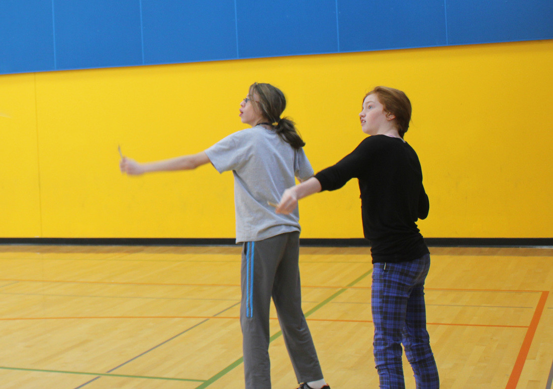 Two girls enthusiastically launch their creations at the Finn Hill building session creations at the Finn Hill building session.